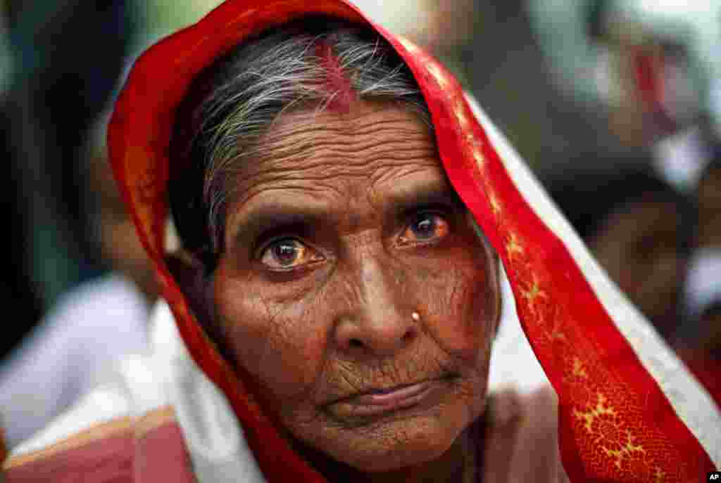 An elderly Anganwadi, or government sponsored child and mother care, worker participates in a protest in New Delhi, India.