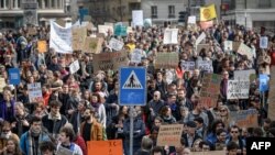 Demonstrators hold placards during a protest against climate change in Lausanne, Switzerland, April 6, 2019.