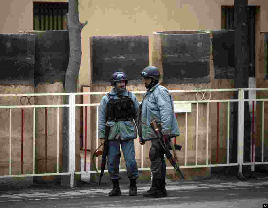 Afghan police patrol the entrance of the Serena hotel in downtown Kabul, March 21, 2014.