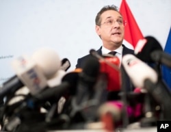 FILE - Austrian Vice Chancellor Heinz-Christian Strache, center, addresses the media during press conference at the sport ministry in Vienna, Austria, May 18, 2019.