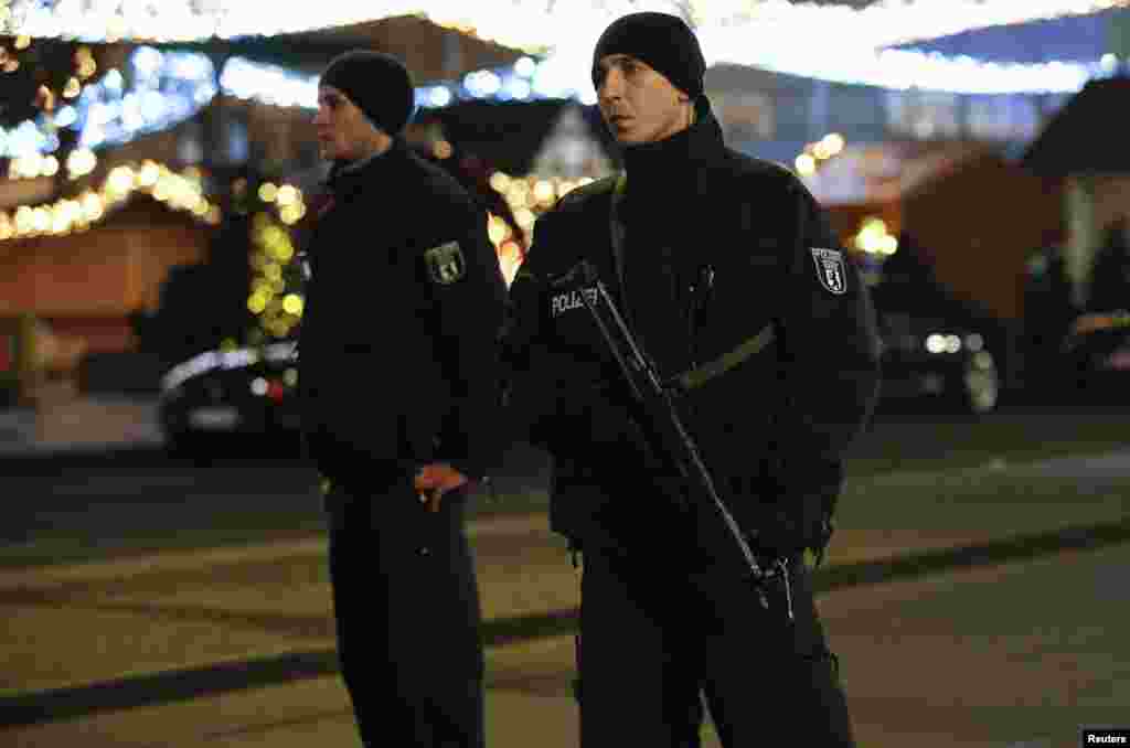 German police officers secure the Christmas market with machine guns, on Breitscheidplatz square in the west of Berlin, Germany, Dec. 19, 2016.