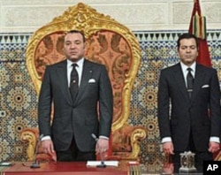 Morocco's King Mohamed VI with his Brother Prince Moulay Rachid, right, listens to the national anthem after he delivered a speech to the nation, March 9, 2011, at the king's Palace in Rabat
