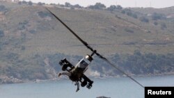 FILE - A Turkish Cobra military helicopter flies during an exercise in Izmir, May 26, 2010.