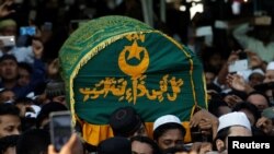 Supporters carry the coffin of Ko Ni, a prominent member of Myanmar's Muslim minority and legal adviser for Myanmar's ruling National League for Democracy, after he was shot dead, in Yangon, Myanmar, Jan. 30, 2017.