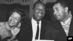 Nat "King" Cole (center) with baseball player Roy Campanella and his wife Ruthe at New York City's Copacabana night club