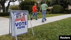 Voters walk to a polling precinct on primary day in Florida for the U.S. presidential election in Boca Raton, Florida, March 15, 2016..