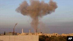Black smoke rises up from bombing by a Syrian forces warplane in Taftanaz village, Idlib province, northern Syria, November 1