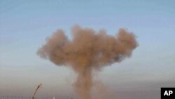 FILE - Black smoke rises up from bombing by a Syrian forces warplane in Taftanaz village, Idlib province, northern Syria, 