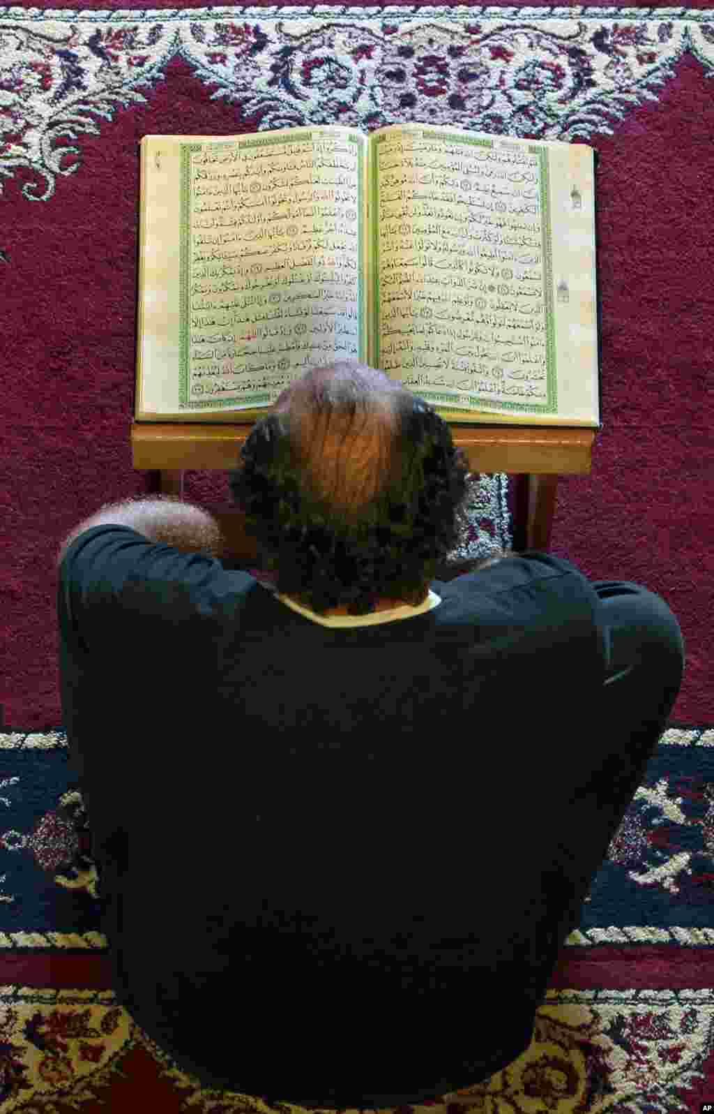 A man reads a Quran at a mosque in Beirut, Lebanon, July 10, 2013.