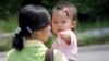 FILE - A North Korean defector carries a baby at the South Korean Hanawon resettlement facility in Anseong, 77 kilometers south of Seoul.