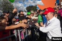 Colombia's President and presidential candidate Juan Manuel Santos greets supporters during the closing campaign rally in Bogota, May 18, 2014.