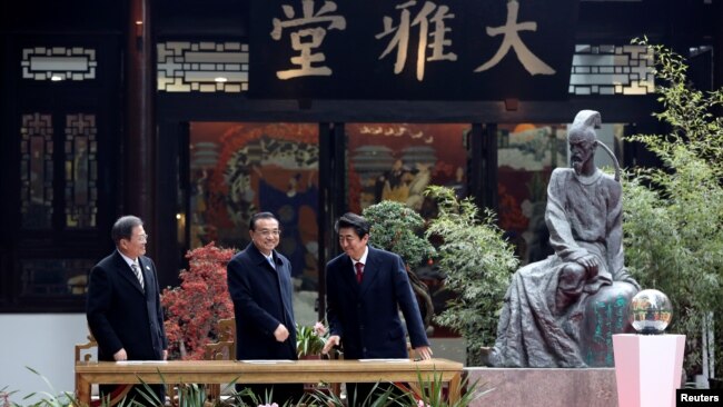 左起:韩国总统文在寅,中国总理李克强和日本首相安倍晋三在成都出席中日韩领导人峰会。(2019年12月24日)
