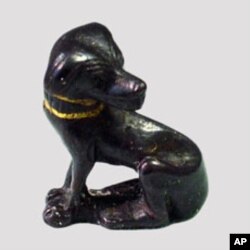 Bronze figurine of a dog with a painted gold collar
