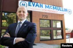 FILE - Third-party candidate Evan McMullin, an independent, poses for a picture outside his campaign offices in Salt Lake City, Utah, Oct. 12, 2016.