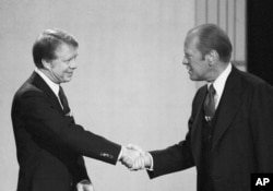 File - President Gerald Ford, right, and Jimmy Carter shake hands before they start their debate.