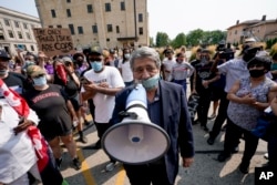 Kenosha Mayor John Antaramian tries to speak to protesters Monday, Aug. 24, 2020, in Kenosha, Wis. (AP Photo/Morry Gash)