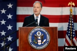 FILE - Then-U.S. Ambassador to Afghanistan James Cunningham announces the results of the U.S. presidential election to the media at the U.S. Embassy in Kabul, Nov. 7, 2012.