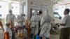 လှိုင်မြို့နယ်ရှိ Quarantine စင်တာမှာ COVID-19 စစ်ဆေးဖို့ ပြင်ဆင်နေတဲ့ ကျန်းမာရေးဝန်ထမ်းများ။ (ဇူလိုင် ၁၆၊ ၂၀၂၀)