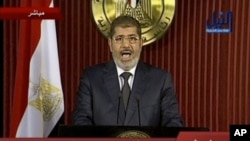 In this image made from video, Egyptian President Mohammed Morsi delivers a televised statement in Cairo, Egypt, Thursday, Dec. 6, 2012.