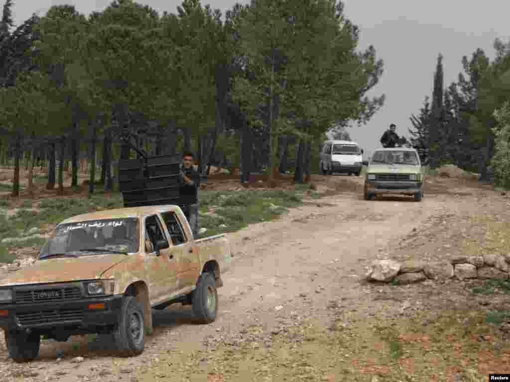Free Syrian Army fighters head towards the frontline in a convoy, Idlib, Syria, April 3, 2013.