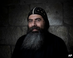 Antonius Orshalimy, Secretary of the Coptic Orthodox Church in Jerusalem poses for a portrait in Jerusalem's Old City, Feb. 11, 2018.
