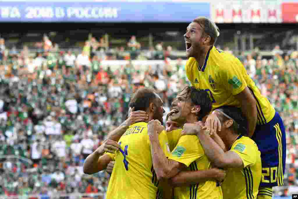 Sweden&#39;s Andreas Granqvist, left, celebrates with teammates after scoring his side&#39;s second goal during the group F match between Mexico and Sweden, at the 2018 soccer World Cup in the Yekaterinburg Arena in Yekaterinburg, Russia.