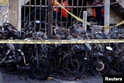Sepeda motor terbakar akibat ledakan bom di salah satu gereja di Surabaya.