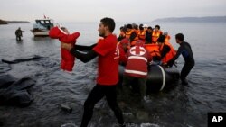 A Red Cross volunteer carries a Syrian refugee baby off an overcrowded raft at a beach on the Greek island of Lesbos, Nov. 16, 2015. Some Republicans are pushing back against aggressive opposition in their party to Syrian refugees resettling in the U.S.