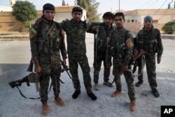 FILE - Kurdish and Arab fighters pose for a picture in Raqqa, northeast Syria, July 22, 2017. Turkey has been wary of Russia's stance towards Kurdish groups in the region.