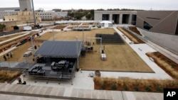Work crews set up a stage beside the new Museum of Mississippi History and the new Mississippi Civil Rights Museum, December 7, in Jackson, Mississippi.