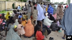 Civilians who fled their homes following an attacked by Islamist militants in Bama, take refuge at a School in Maiduguri, Nigeria, Sept. 3, 2014.
