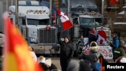 Truckers and supporters continue to protest COVID-19 vaccine mandates in front of Parliament Hill in Ottawa, Ontario, Canada, Feb. 1, 2022.