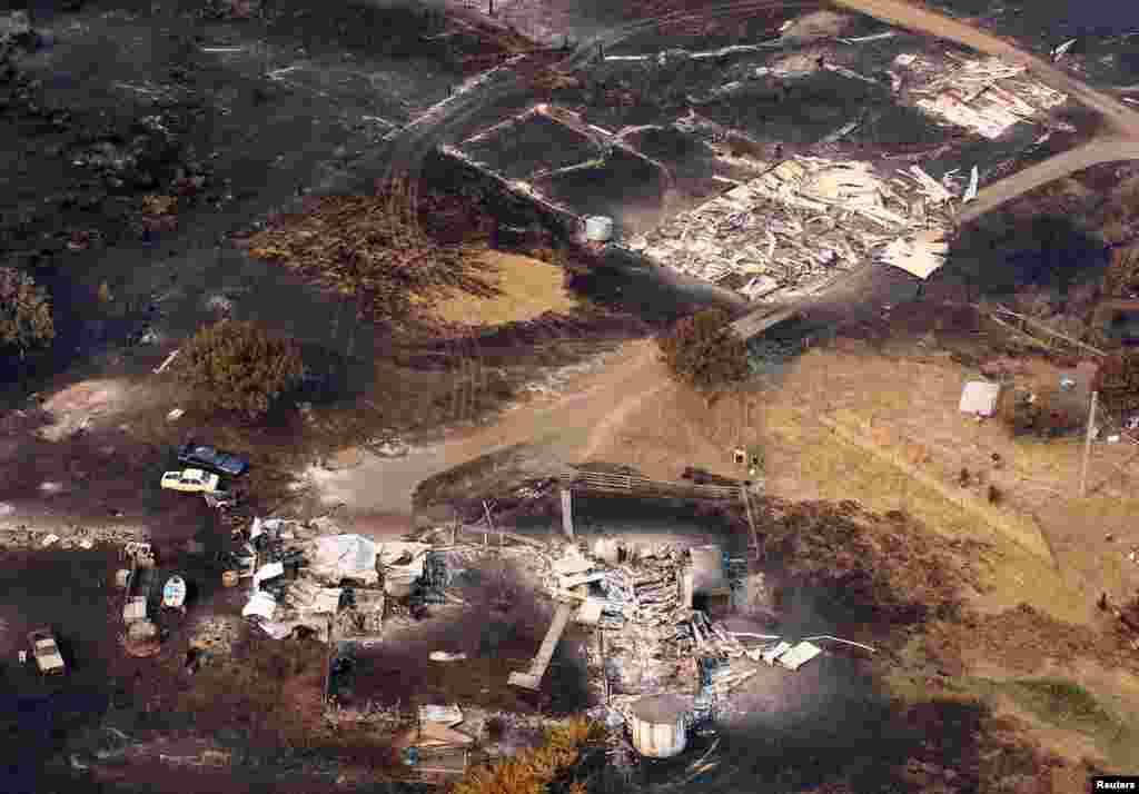 Houses destroyed by a wildfire are seen in ruins in Dunalley, east of Hobart, Australia, January 5, 2013.