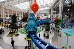 Visitors to the American Dream mega entertainment and shopping complex in East Rutherford, N.J., ride Dora's Sky Railway, Friday, Oct. 25, 2019. (AP Photo/Richard Drew)