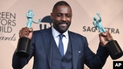 Idris Elba poses in the press room with the award for outstanding male actor in a supporting role for “Beasts of No Nation” and the award for outstanding male actor in a TV movie or miniseries for “Luther” at the 22nd annual Screen Actors Guild Awards at 