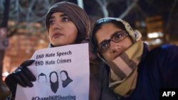 Women take part in a vigil for three young Muslims killed in Chapel Hill, North Carolina, at Dupont Circle in Washington, D.C., Feb. 12, 2015