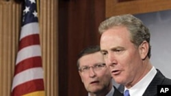 Rep. Chris Van Hollen (r) accompanied by Senate Budget Committee Chairman Sen. Kent Conrad speaks about the Congressional Budget Office's economic outlook during a news conference on Capitol Hill, Jan 26 2011
