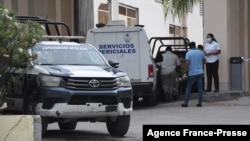 Expert services workers are seen outside the Hyatt Ziva Riviera hotel in Puerto Morelos, Quintana Roo state, Mexico, on Nov. 4, 2021, after a shooting. 