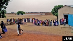 Community members in line to receive drugs during a mass drug administration (MDA) in Mali. 