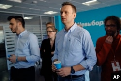 Russian opposition leader Alexei Navalny observes the election progress at his Foundation for Fighting Corruption office, in Russia, Sunday, March 18, 2018.