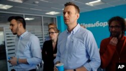 Russian opposition leader Alexei Navalny observes the election progress at his Foundation for Fighting Corruption office, in Russia, Sunday, March 18, 2018.