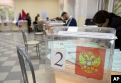 Election officials prepare ballots at a polling station ahead of parliamentary elections in Moscow, Russia, Sept. 17, 2016.