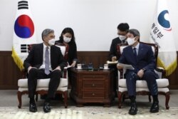 FILE - U.S. Special Representative for North Korea, Sung Kim, left, and South Korean Unification Minister Lee In-young meet to discuss North Korea issues at the unification ministry in Seoul, South Korea, June 22, 2021.