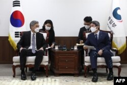 FILE - U.S. Special Representative for North Korea, Sung Kim, left, and South Korean Unification Minister Lee In-young meet to discuss North Korea issues at the unification ministry in Seoul, South Korea, June 22, 2021.