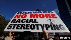 A supporter carrying a "Harvard No More Racial Stereotyping" sign attends the "Rally for the American Dream - Equal Education Rights for All," ahead of the start of the trial in a lawsuit accusing Harvard University of discriminating against Asian-Americans.