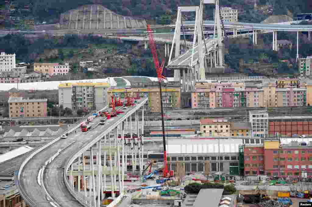 Crews work on the partly collapsed Morandi Bridge in the port of Genoa, Italy.