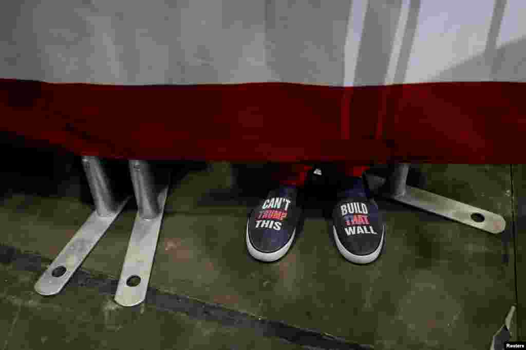 A rallygoer&#39;s shoes are seen during a campaign rally with U.S. President Donald Trump in Estero, Florida, Oct. 31, 2018.