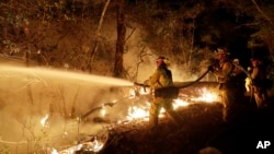 Fire crews battle a wildfire in Santa Rosa, California, Oct. 14, 2017.