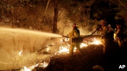 Fire crews battle a wildfire in Santa Rosa, California, Oct. 14, 2017.