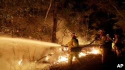 Fire crews battle a wildfire in Santa Rosa, California, Oct. 14, 2017.